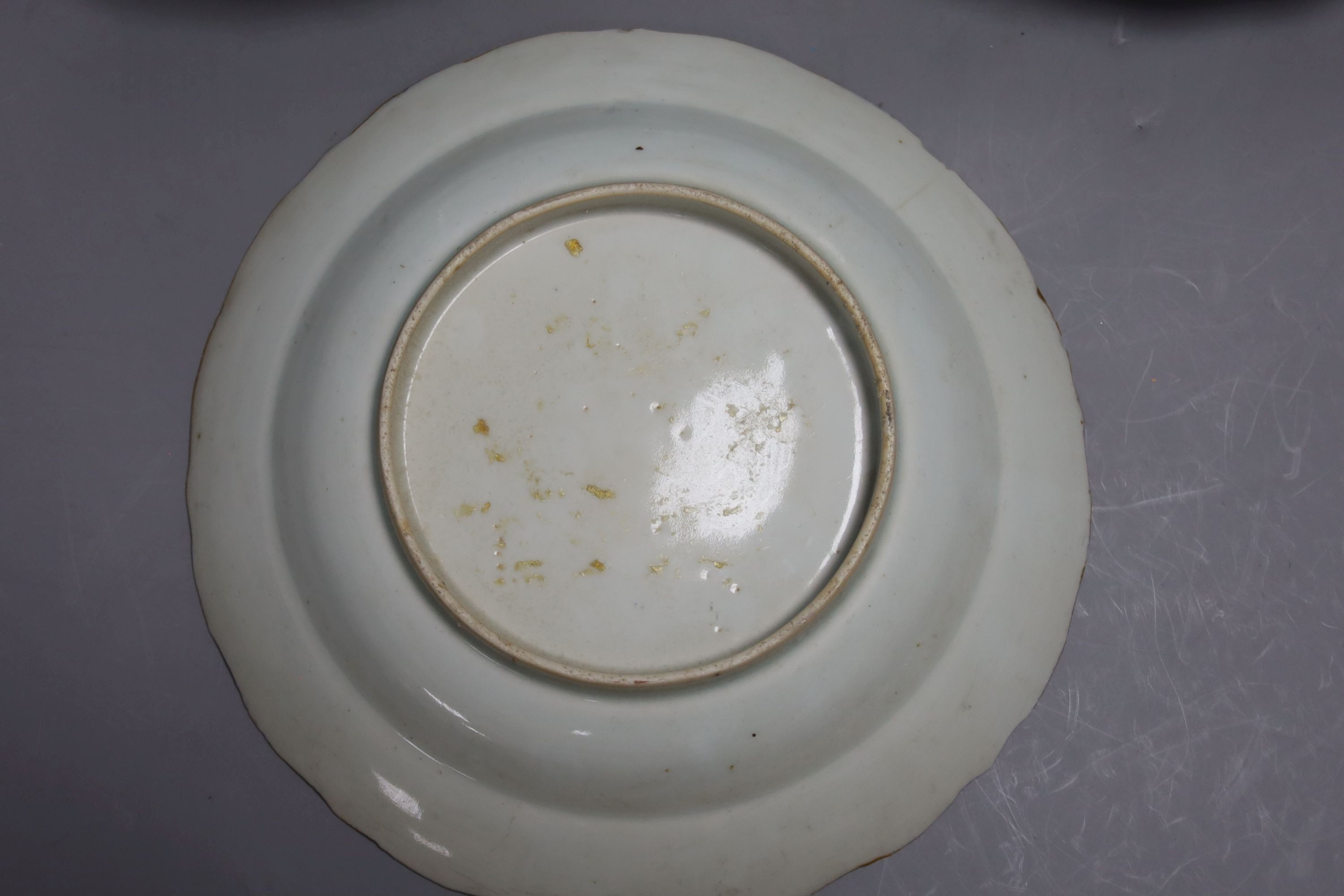 A set of eight Chinese plates with orange 'lotus' centres and blue floral borders, Qing dynasty, Dia 20cm
